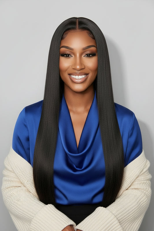 Woman with long straight black hair against a gray background