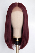 Lifestyle view of model wearing burgundy straight glueless human hair wig