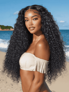 Woman with long, wavy hair on a beach with ocean and sky in the background