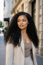 Woman with long, curly hair standing on a city street