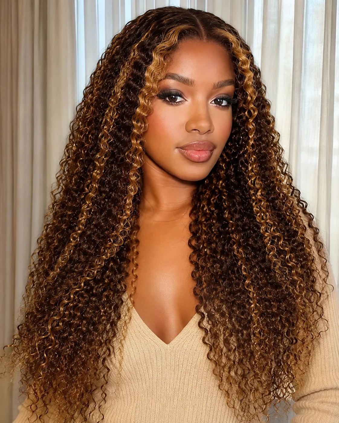 Front view of honey blonde kinky curly lace front human hair wig on model