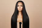 Mannequin head with long black straight wig on a brown background