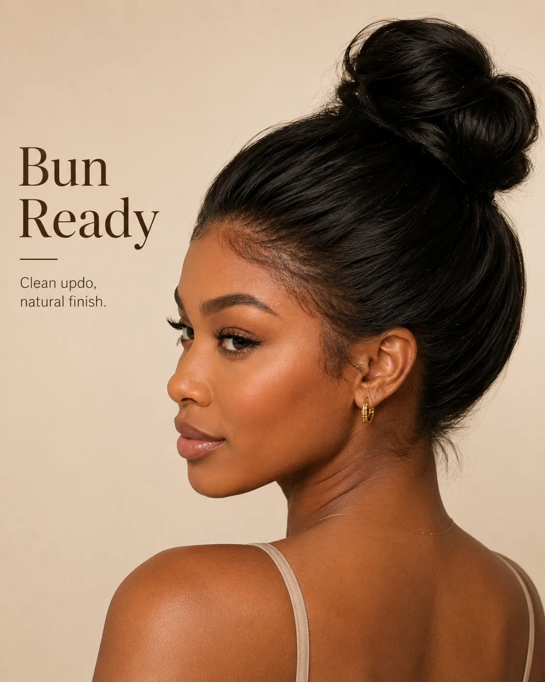 Woman with styled hair in a bun against a beige background