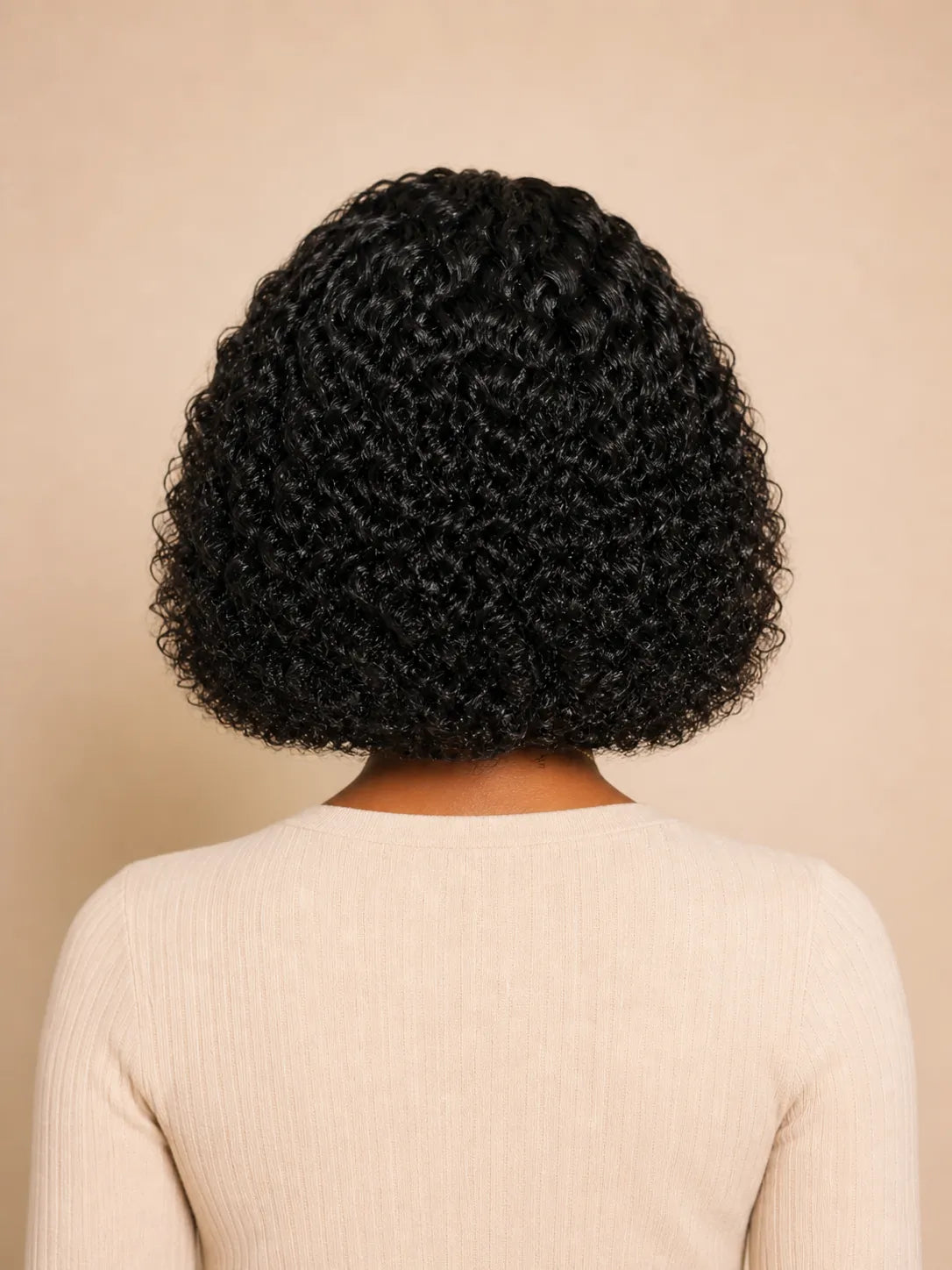 Close-up view of curly human hair wig texture and lace detail with soft texture and natural finish