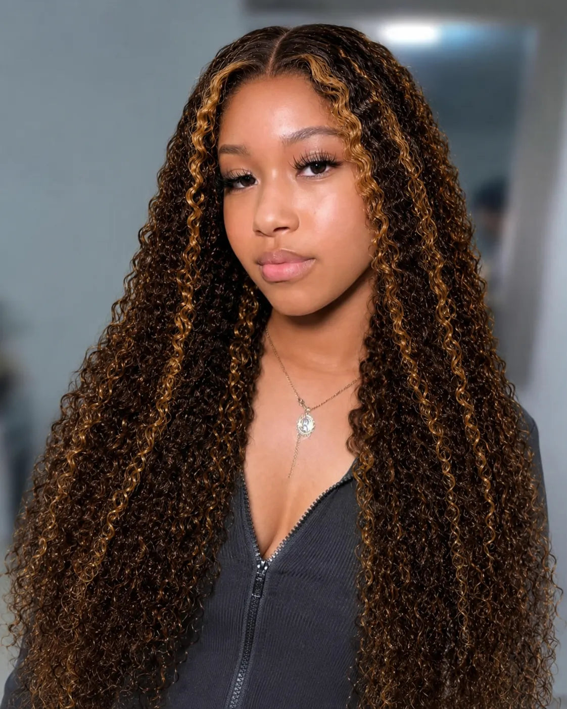 Back view of honey blonde kinky curly human hair wig with natural volume