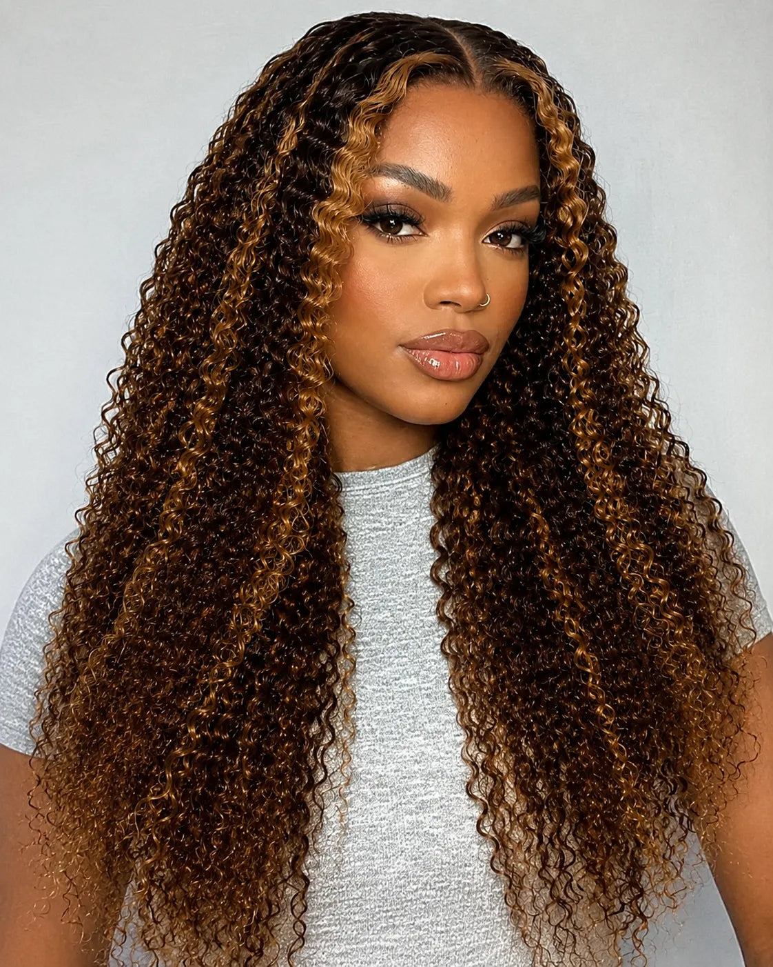Lifestyle view of model wearing honey blonde kinky curly glueless human hair wig