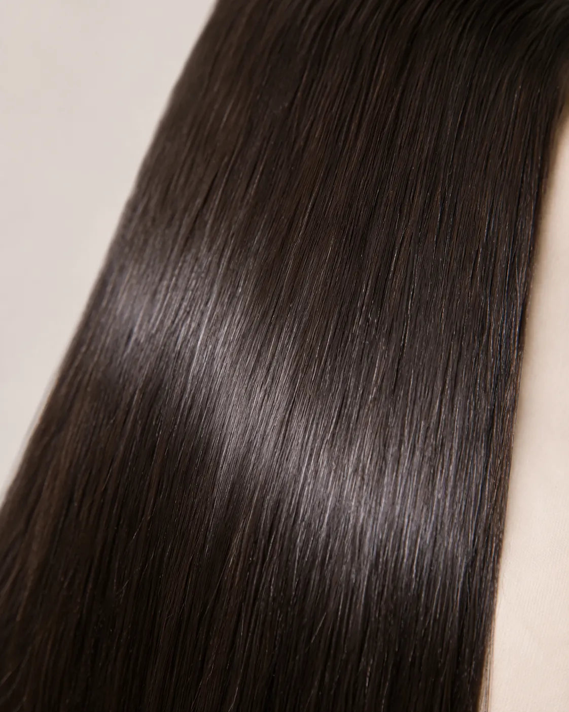 Lifestyle view of model wearing brown straight glueless human hair wig
