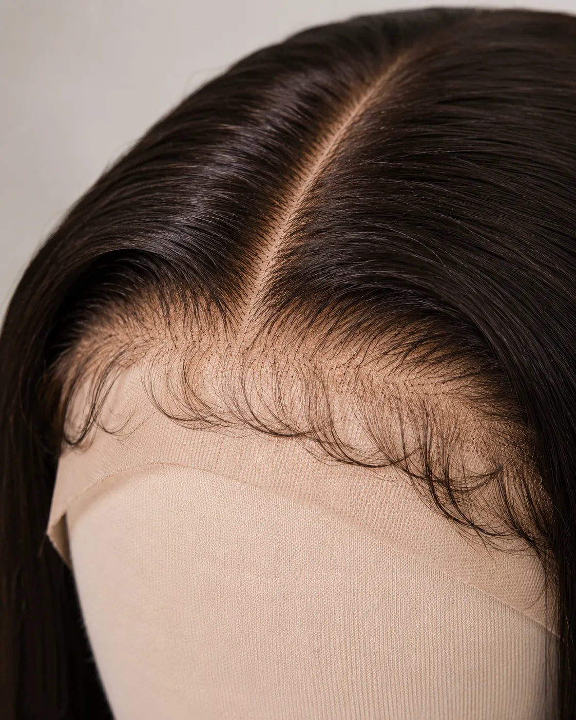 Close-up view of brown straight human hair wig texture and lace detail