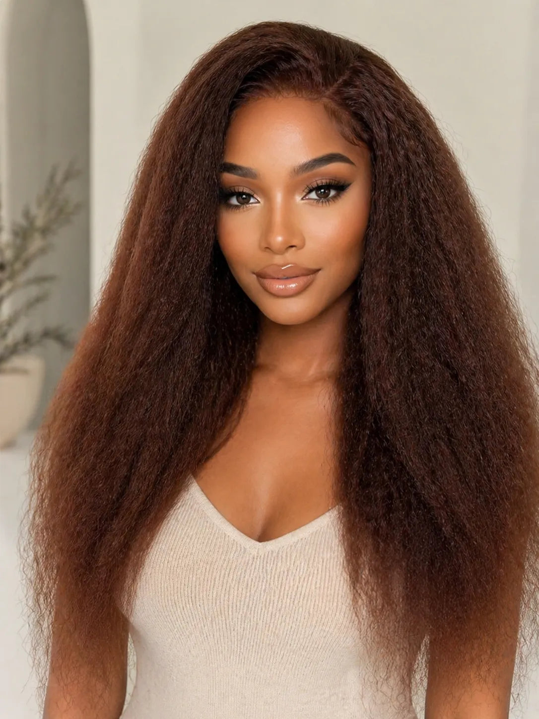 Product detail view of brown kinky straight human hair wig with soft texture and natural finish