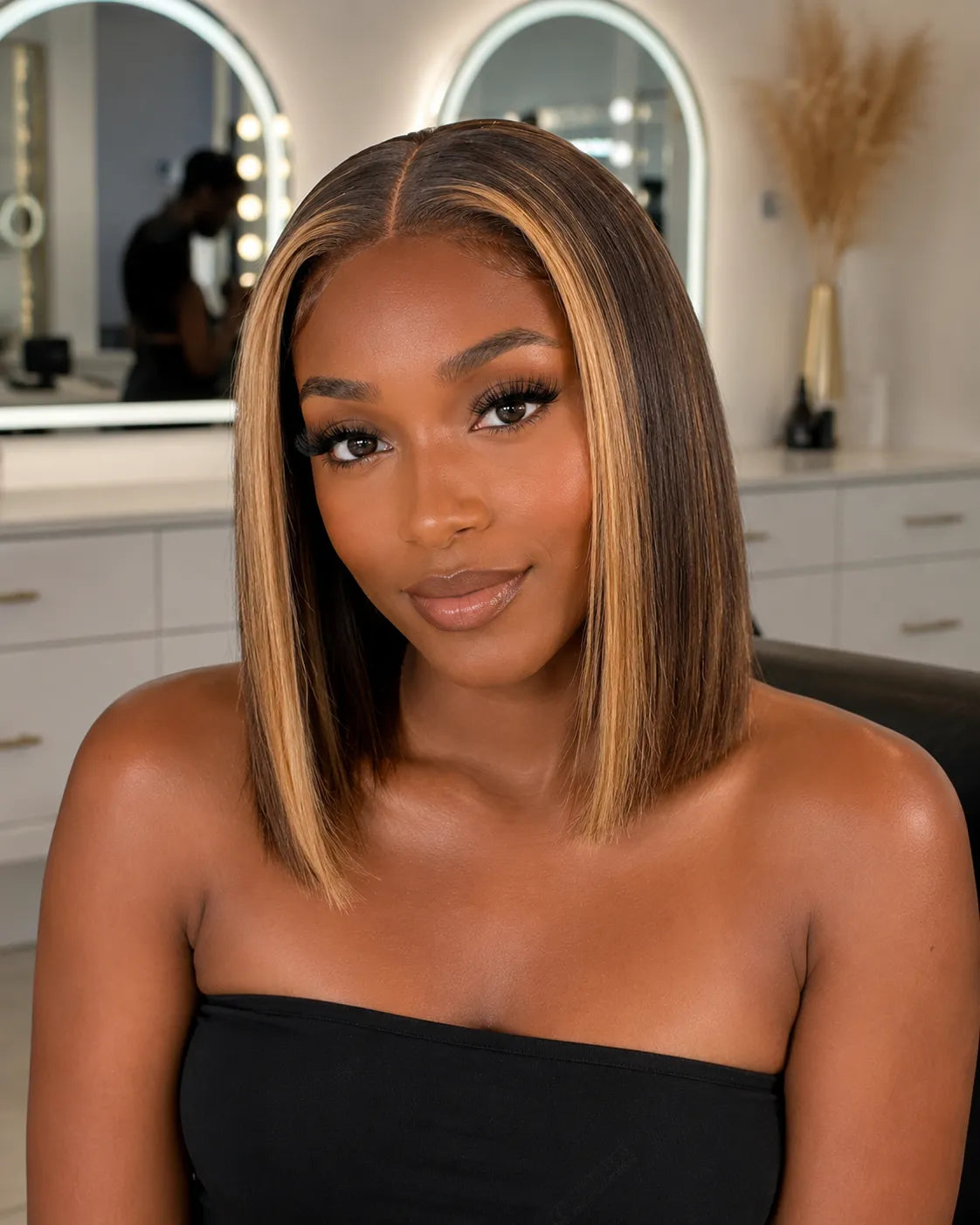 Lifestyle view of model wearing blonde straight human hair wig with soft texture and natural finish