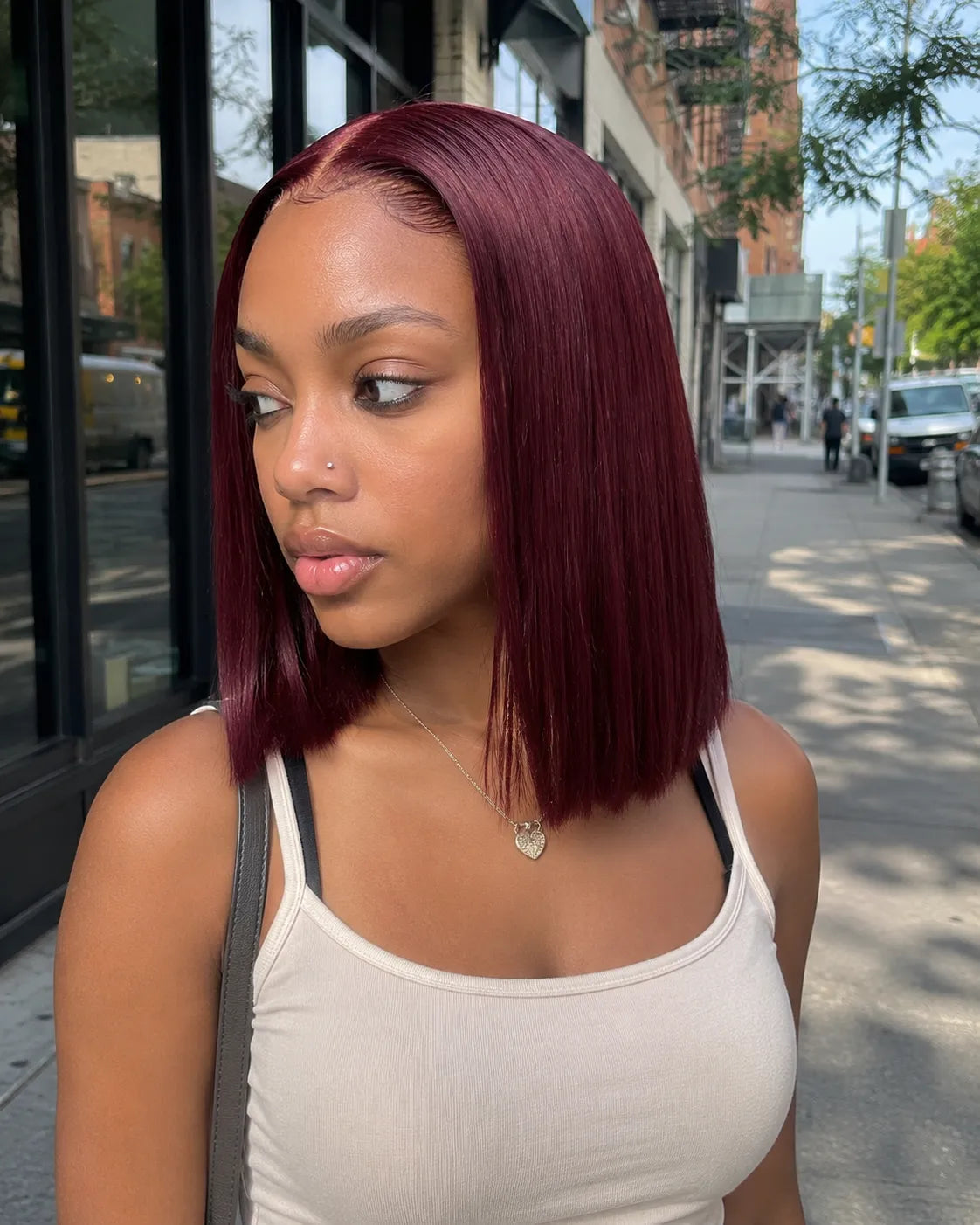 Lifestyle view of model wearing straight human hair wig with soft texture and natural finish