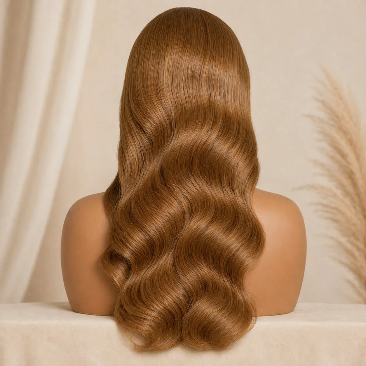 Mannequin head with long, wavy brown hair against a beige background