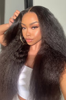 Woman with long, straight hair styled in a way that it frames her face.