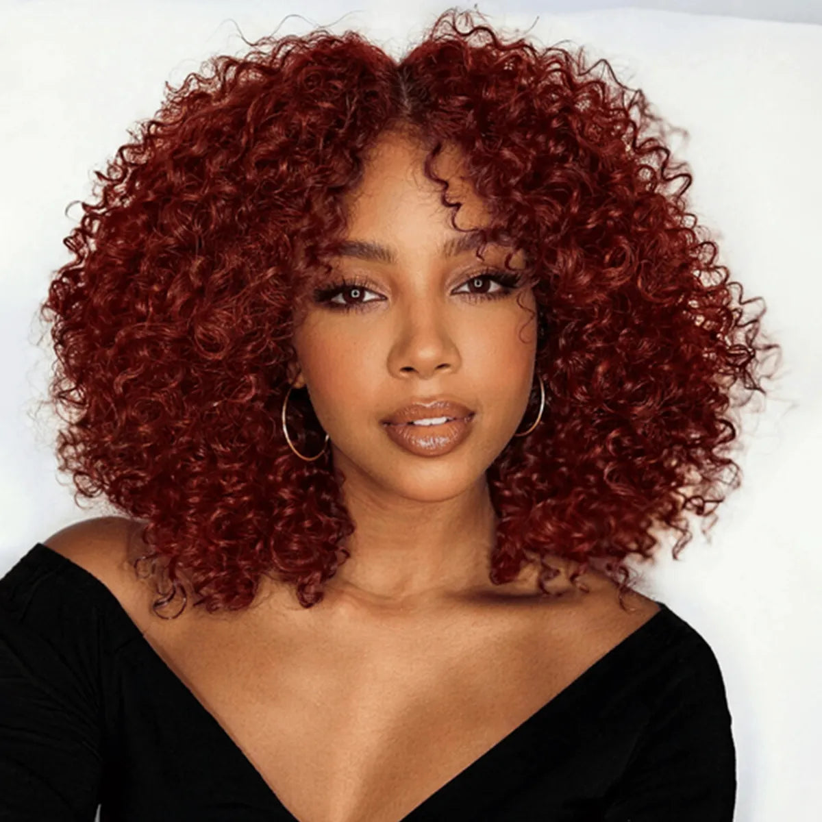 Side view of brown kinky curly lace wig showing natural hairline with soft texture and natural finish